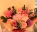 Pink and cream mixed flower bouquet with purple accents in peach-pink wrapping